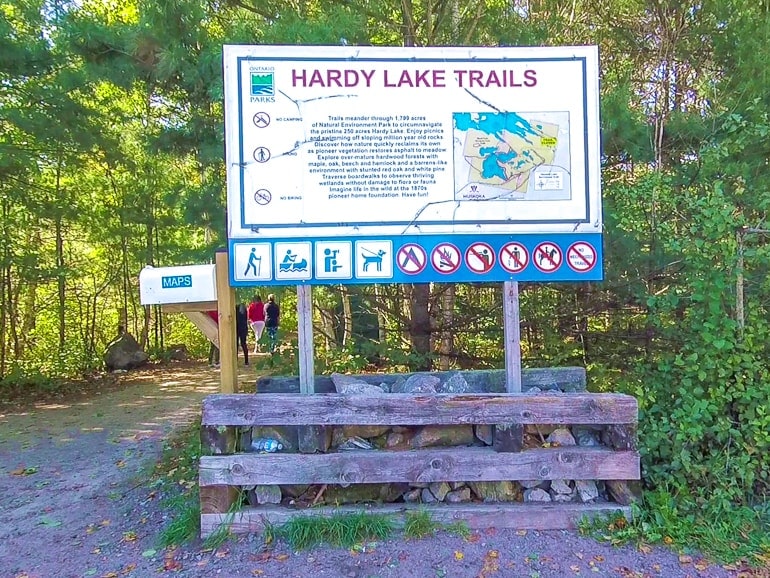 white sign with map to trail system for provincial park in ontario.