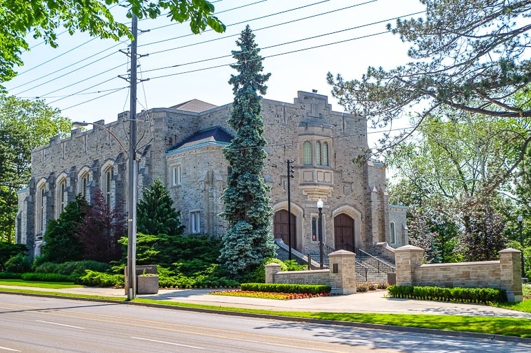 large grey stone building beside road in guelph.