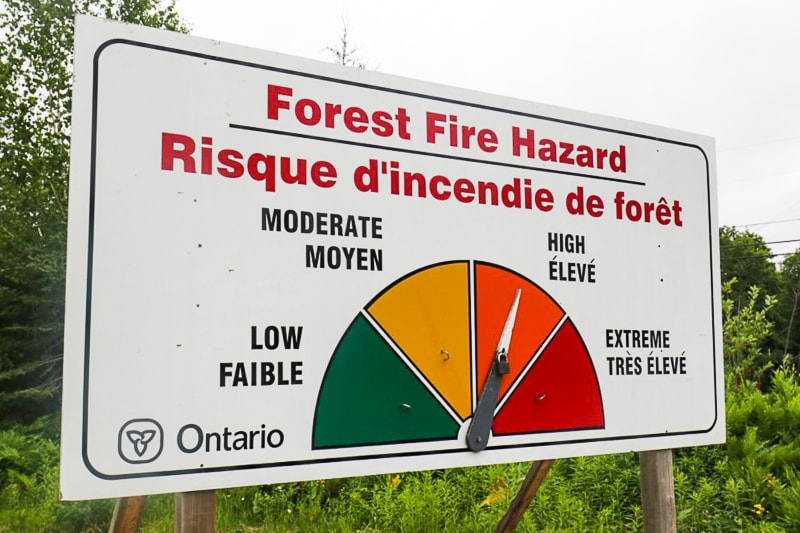 fire hazard board in forest with colourful scale.